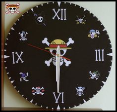 a black clock with skulls and bones on it