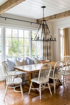 a dining room table with white chairs around it