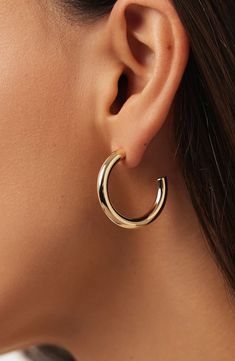 Our large chunky gold hoop earrings are a bold, solid gold statement piece for the modern trendsetter. Elevate your style with these eye-catching and super unique hoops that effortlessly blend timeless elegance with contemporary flair. Waterproof, tarnish-proof recycled solid gold Wear on its own or part of a stack Timeless, solid gold that goes with everything Width: 28.3mm - 1.11" Depth: 4mm - 0.15" Weight:1.38g Hoop Diameter: 28.3mm - 1.11" Post: 10K Solid Gold Post Crafted In Italy Chunky Gold Hoop Earrings, Anniversary Sale, Gold Hoop, Gold Hoop Earrings, Trend Setter, The Modern, Timeless Elegance, Solid Gold, Gold Earrings