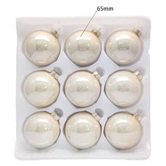 twelve white glass baubles in a package