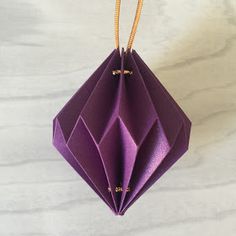 a purple origami hanging from a string