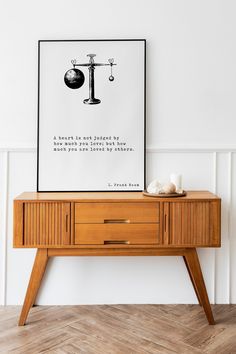 a poster with a balance scale on it next to a wooden table and lamppost