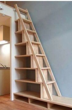 a wooden stair case in an empty room