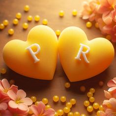 two heart shaped candies with the letters r and person on them surrounded by flowers