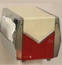 a red and white toaster sitting on top of a counter