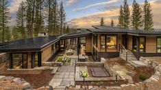 a modern home surrounded by trees and rocks