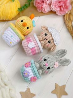 small crocheted stuffed animals sitting next to each other on a white wooden surface