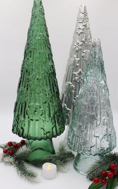 two green glass trees sitting next to each other