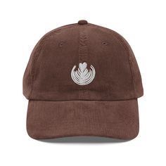 Show off your love for coffee with our stylish "Latte heART" embroidered corduroy hat! This trendy cap features a stunning latte art design with a classic Rosetta and a heart, brought to life with premium puff 3D embroidery. Perfect for coffee enthusiasts, baristas, and anyone who appreciates the art of a perfect brew, this hat is a must-have for your collection. Made from 100% cotton corduroy, the "Latte heART" hat is soft, comfortable, and perfect for everyday wear. Its unstructured, 6-panel, Coffee Shop Hat, Barista Gift, Trendy Caps, Embroidered Corduroy, Corduroy Hat, 3d Embroidery, Coffee Culture, Coffee Enthusiast, Coffee Design