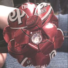 a close up of a person's hand holding a bunch of candy