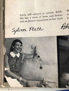 an old photo of a woman sitting next to a cow with words written on it