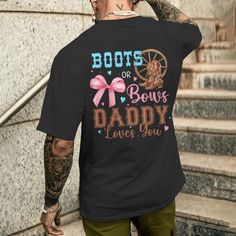 a man with tattoos wearing a black t - shirt that says boots or bows, daddy loves you