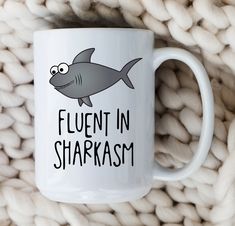 a white coffee mug that says fluent in sharasm with a shark on it