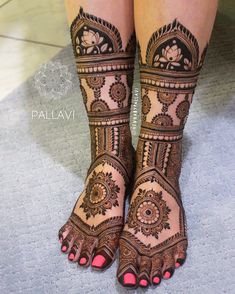 the legs and feet of a woman with henna tattoos