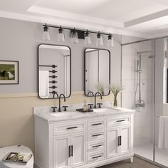 a bathroom with two sinks and mirrors on the wall