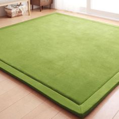 a large green rug in the middle of a room