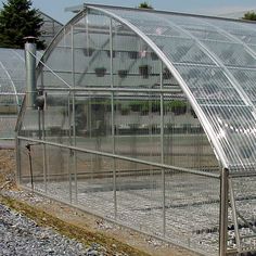 a large greenhouse with many plants inside of it