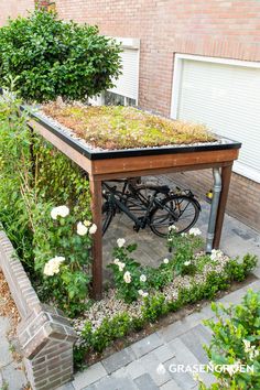 a bicycle is parked under a green roof