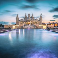 a large building with a fountain in front of it