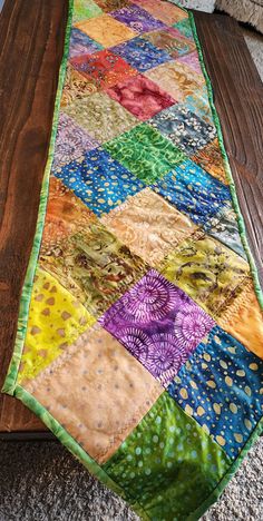 a multicolored table runner is sitting on the floor