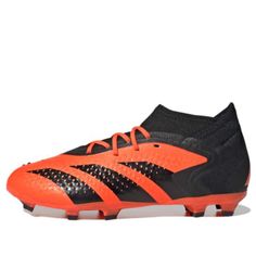 the adi predator soccer shoe in black and orange