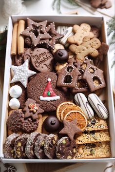 a box filled with lots of different types of cookies and pastries on top of a table