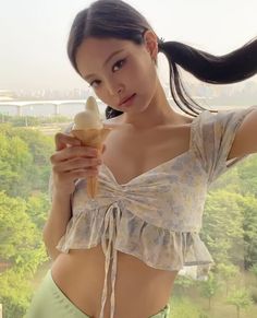 a woman holding an ice cream cone in her hand