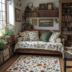 a living room filled with lots of furniture and bookshelves next to a window