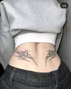 a woman's stomach with tattoos on it