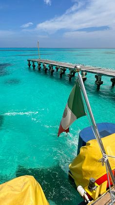 the water is crystal blue and clear with some boats docked on it's side