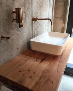 a bathroom with a sink and wooden counter top