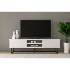 a white entertainment center with a flat screen tv