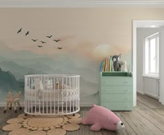 a baby's room decorated in pastel colors with mountains and birds painted on the wall