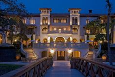 the entrance to a mansion lit up at night