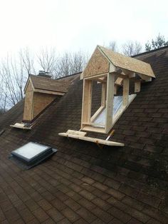 an attic window being installed on top of a roof