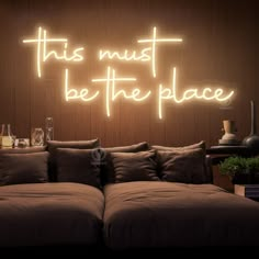 this must be the place neon sign above a couch