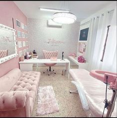 a room with pink furniture and pictures on the wall, including a couch, chair, desk, and mirror