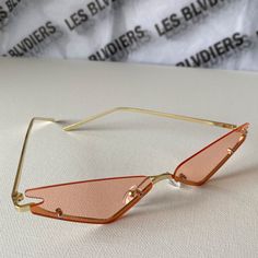 Retro meets modern in these trendy triangle lens sunglasses. Pink lenses and narrow frame make these the ultimate trendy accessory. 70s Glasses, Narrow Sunglasses, Pink Lenses, Pink Triangle, Makeup Accesories, Sunglasses Pink, Trendy Accessories, Character Aesthetic, Lenses