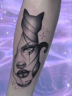 a woman's face with a cat on her head and an abstract line work tattoo