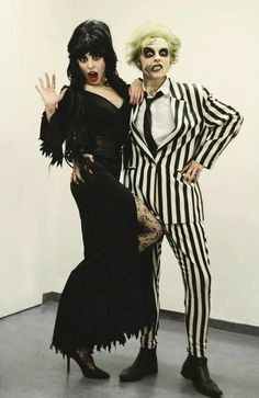 two people dressed up as beetle and the person in striped suit are standing next to each other