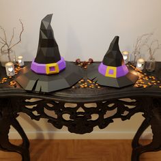 two witches hats sitting on top of a table