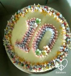 a birthday cake with the letter d on it and sprinkles in the middle