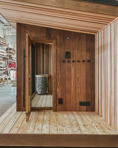 the inside of a building with wooden floors and walls that are covered in wood slats