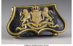 a black and gold purse with two lions on the front, one holding a crown