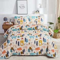 a bed covered in animal themed sheets and pillows