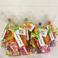 several bags filled with candy sitting on top of a counter