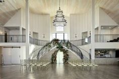 a large room with white walls and wooden floors, decorated for an event or wedding