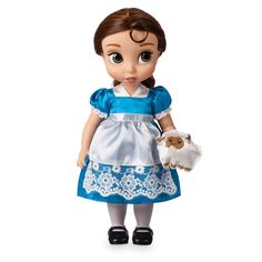 the doll is wearing a blue dress and holding a small white cow in her hand