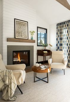 a living room filled with furniture and a fire place in the middle of the room