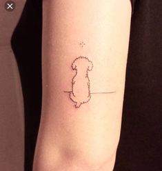 a woman's arm with a small outline of a dog on the left side